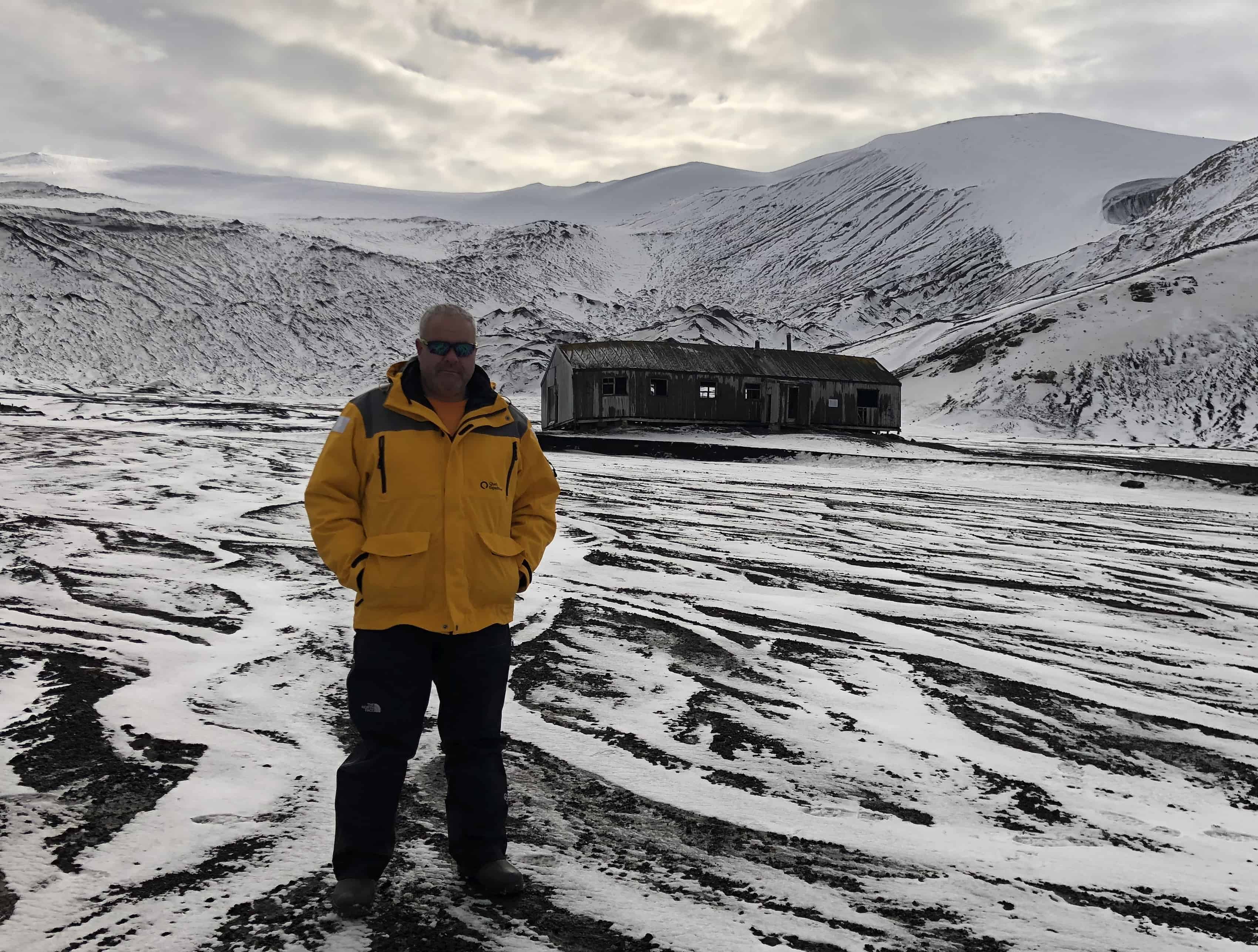 Standing in front of an old abandoned whaling shack on Deception Island, Antarctica